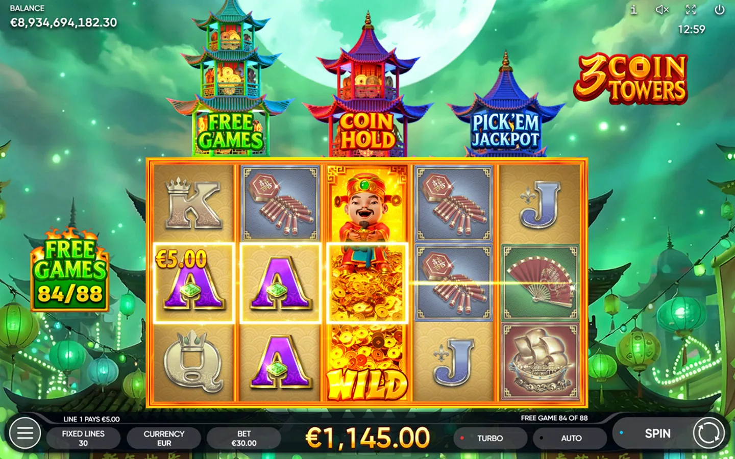 3 Coin Towers Free Games with the God of Wealth wild expanded on the middle reel and the counter reading 84 of 88