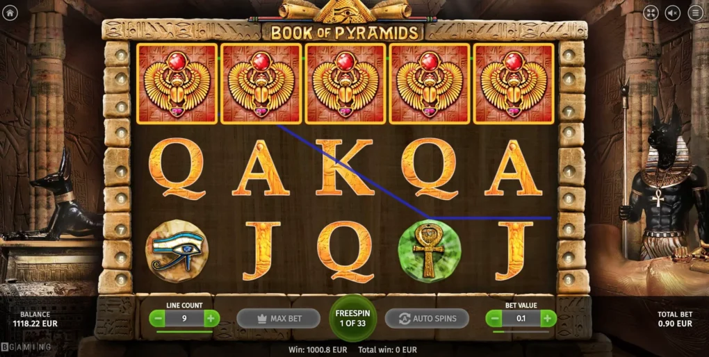 Book of Pyramids free spins with five Scarabs across the top row and the counter reading FREESPIN 1 OF 33