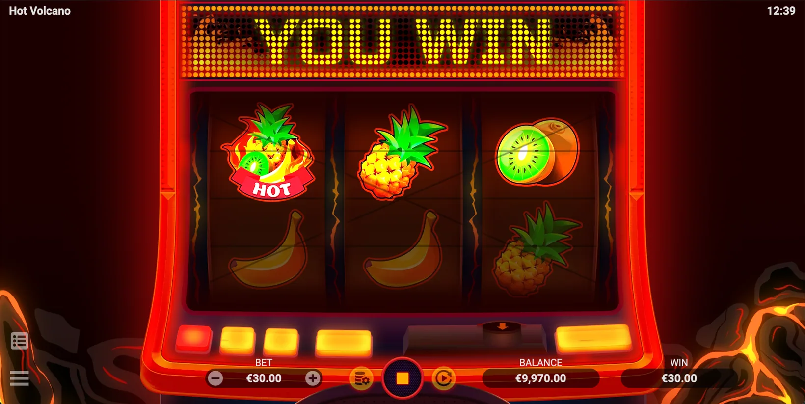 A winning HOT line on the Hot Volcano reels, the red wild banner completing a combination with pineapple and kiwi